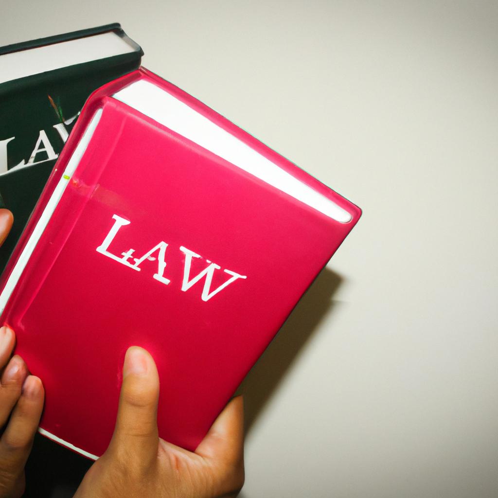 Person holding law books, studying